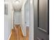 Bright hallway featuring hardwood floors and neutral paint, creating a seamless transition between rooms at 4653 Ridgewood Dr, Forest Park, GA 30297