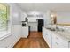 The remodeled kitchen features white cabinets, subway tile backsplash, and modern appliances at 4653 Ridgewood Dr, Forest Park, GA 30297