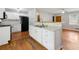 Bright kitchen with white cabinets, granite countertops, and open view to the living area at 4653 Ridgewood Dr, Forest Park, GA 30297