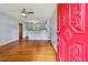 Inviting living room features hardwood floors, ceiling fan, and view into updated kitchen at 4653 Ridgewood Dr, Forest Park, GA 30297