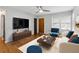 Stylishly staged living room features hardwood floors, and neutral tones at 4653 Ridgewood Dr, Forest Park, GA 30297