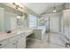 Luxurious bathroom with a soaking tub, a separate shower, and dual sinks with pristine white counters at 5615 Toccoa Dr, Douglasville, GA 30135