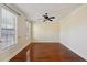 Spacious bedroom with hardwood floors, a ceiling fan, and large windows at 5615 Toccoa Dr, Douglasville, GA 30135
