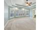 Serene primary bedroom with tray ceilings, a ceiling fan, and large windows offering great lighting at 5615 Toccoa Dr, Douglasville, GA 30135
