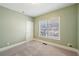 Neutral bedroom featuring a window and neutral carpet at 5615 Toccoa Dr, Douglasville, GA 30135