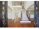 Elegant foyer with hardwood floors, a staircase, and arched doorways that exude modern appeal at 5615 Toccoa Dr, Douglasville, GA 30135