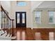 Bright, open foyer features gleaming hardwood floors, black wrought iron railings, and double doors at 5615 Toccoa Dr, Douglasville, GA 30135