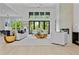 Bright living room with modern furniture, fireplace, and large windows overlooking the backyard at 292 Highway 279, Fayetteville, GA 30214