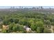 Lush, green canopy surrounds neighborhood homes with a skyline view in the background at 1380 Wayne Ne Ave, Atlanta, GA 30306