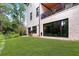 Spacious backyard featuring a lush green lawn and a white brick home at 1380 Wayne Ne Ave, Atlanta, GA 30306