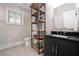 Modern bathroom showcasing a black vanity with marble countertop and an industrial style shelf unit at 1380 Wayne Ne Ave, Atlanta, GA 30306