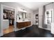 Bathroom featuring sleek floating vanity, dark tile flooring and direct access to the walk-in closet at 1380 Wayne Ne Ave, Atlanta, GA 30306