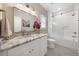 Bright bathroom featuring marble countertop, decorative tile, and sleek glass shower enclosure at 1380 Wayne Ne Ave, Atlanta, GA 30306