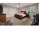 Modern bedroom featuring a wooden bed, large window, and a sleek ceiling fan at 1380 Wayne Ne Ave, Atlanta, GA 30306