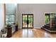 Bright foyer with hardwood floors, grand entryway, and staircase with black accents at 1380 Wayne Ne Ave, Atlanta, GA 30306
