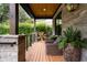 Inviting front porch with stone pillars, wood ceiling, and wicker seating at 1380 Wayne Ne Ave, Atlanta, GA 30306