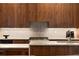 Elegant kitchen featuring wood cabinets, a stylish tile backsplash, and marble countertops at 1380 Wayne Ne Ave, Atlanta, GA 30306