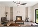 Cozy living room featuring a painted brick fireplace, leather chair and ample seating at 1380 Wayne Ne Ave, Atlanta, GA 30306