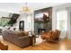 Bright living room featuring hardwood floors, a modern fireplace, and stylish chandelier at 1380 Wayne Ne Ave, Atlanta, GA 30306