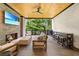 Inviting covered outdoor living space with a stone fireplace, TV, and comfortable seating at 1380 Wayne Ne Ave, Atlanta, GA 30306