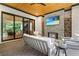 Cozy outdoor living space with a brick fireplace, TV, comfortable seating, and wood storage at 1380 Wayne Ne Ave, Atlanta, GA 30306