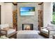 Charming outdoor fireplace with stone surround, wood storage, and comfortable seating at 1380 Wayne Ne Ave, Atlanta, GA 30306