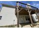 Exterior view showing back deck with support beams and a concrete patio at 2517 Oak Valley Ln, Dacula, GA 30019