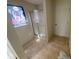 Tiled bathroom featuring a shower with sliding glass doors and a decorative curtain at 2517 Oak Valley Ln, Dacula, GA 30019