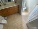 This bathroom has neutral tile flooring and a sink with wooden cabinets at 2517 Oak Valley Ln, Dacula, GA 30019