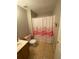 Charming bathroom with a flamingo shower curtain, tiled floors, and a wooden vanity with ample counter space at 2517 Oak Valley Ln, Dacula, GA 30019