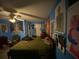A blue bedroom with a ceiling fan, black tapestry, and various posters on the blue walls at 2517 Oak Valley Ln, Dacula, GA 30019