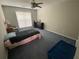 Comfortable bedroom with a ceiling fan, window, and carpeted floors, ideal for relaxation at 2517 Oak Valley Ln, Dacula, GA 30019