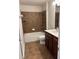 This bathroom features a shower and tub combo with a large vanity at 5669 Avonley Creek Dr, Sugar Hill, GA 30518
