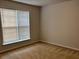 Bedroom with carpeted floors and a window at 5669 Avonley Creek Dr, Sugar Hill, GA 30518