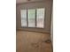 Carpeted bedroom featuring natural light from large windows with blinds at 5669 Avonley Creek Dr, Sugar Hill, GA 30518