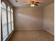 Bright bedroom with natural light, neutral carpet, and a ceiling fan at 5669 Avonley Creek Dr, Sugar Hill, GA 30518
