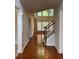 Inviting entryway with hardwood floors, staircase, and lots of natural light from the transom windows at 5669 Avonley Creek Dr, Sugar Hill, GA 30518