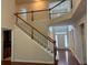 Welcoming foyer with hardwood floors, staircase, and large windows for natural light at 5669 Avonley Creek Dr, Sugar Hill, GA 30518