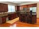 Well-equipped kitchen with stainless steel appliances, breakfast bar, and wooden cabinetry at 5669 Avonley Creek Dr, Sugar Hill, GA 30518