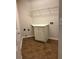A laundry room with tile floor, cabinets and wire shelving at 5669 Avonley Creek Dr, Sugar Hill, GA 30518