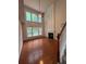 Spacious living room featuring hardwood floors, fireplace, and large windows at 5669 Avonley Creek Dr, Sugar Hill, GA 30518
