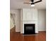 Cozy living room featuring a fireplace, ceiling fan, and wood flooring at 5669 Avonley Creek Dr, Sugar Hill, GA 30518