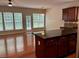 Hardwood floors and natural light fill this living room and open-concept kitchen at 5669 Avonley Creek Dr, Sugar Hill, GA 30518