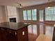 Bright living room with fireplace, natural light, and hardwood flooring at 5669 Avonley Creek Dr, Sugar Hill, GA 30518