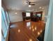 Open-concept living space with hardwood floors, island, stainless steel appliances at 5669 Avonley Creek Dr, Sugar Hill, GA 30518