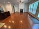 Open-concept living space with hardwood floors, fireplace, island, and natural light at 5669 Avonley Creek Dr, Sugar Hill, GA 30518