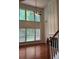 A sun drenched living room featuring hardwood floors, and a fire place at 5669 Avonley Creek Dr, Sugar Hill, GA 30518