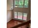 A sun drenched living room with hardwood floors and plenty of windows at 5669 Avonley Creek Dr, Sugar Hill, GA 30518