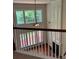 Loft with tall windows, a ceiling fan, and a view of the fireplace below at 5669 Avonley Creek Dr, Sugar Hill, GA 30518