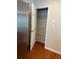 Walk-in pantry with shelving and door to provide extra storage space next to the refrigerator at 5669 Avonley Creek Dr, Sugar Hill, GA 30518